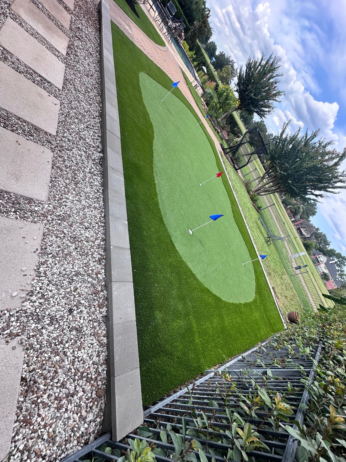 Artificial turf putting green with landscape border