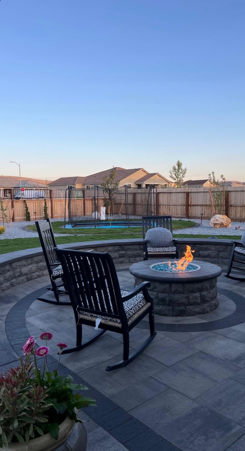 Round fire pit with paver seating area